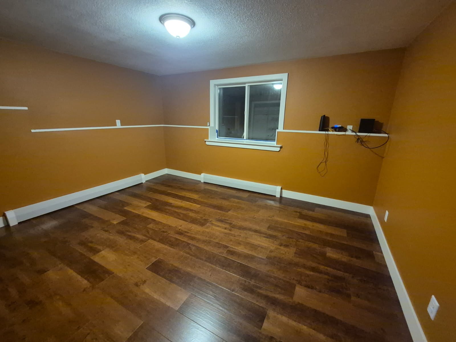 Finished room with white baseboards, chair rail, and window casing in Missoula